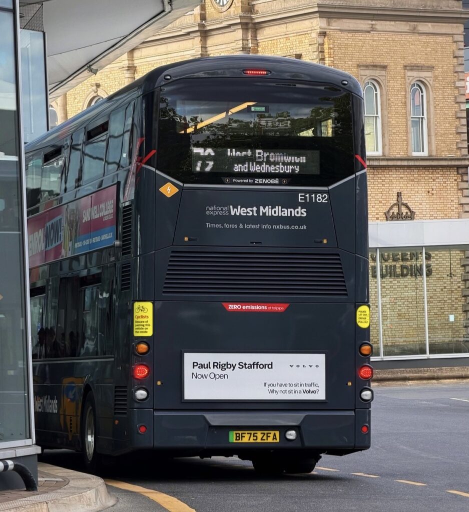 Rear of bus showing advertisement for Paul Rigby Volvo car dealership